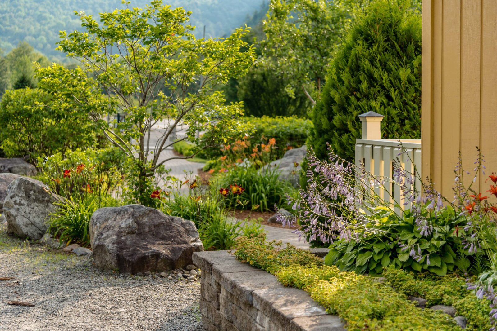 stone-wall-hardscaping-and-landscaping-in-yard-